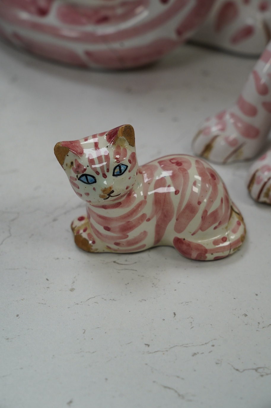 A large 1950's Italian pink maiolica seated cat and two smaller, largest 45cm. Condition - poor